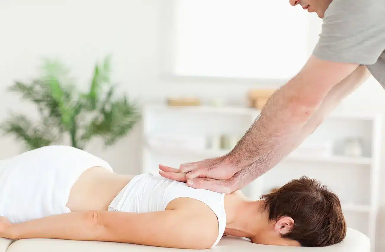 Chiropractor adjusting patients back